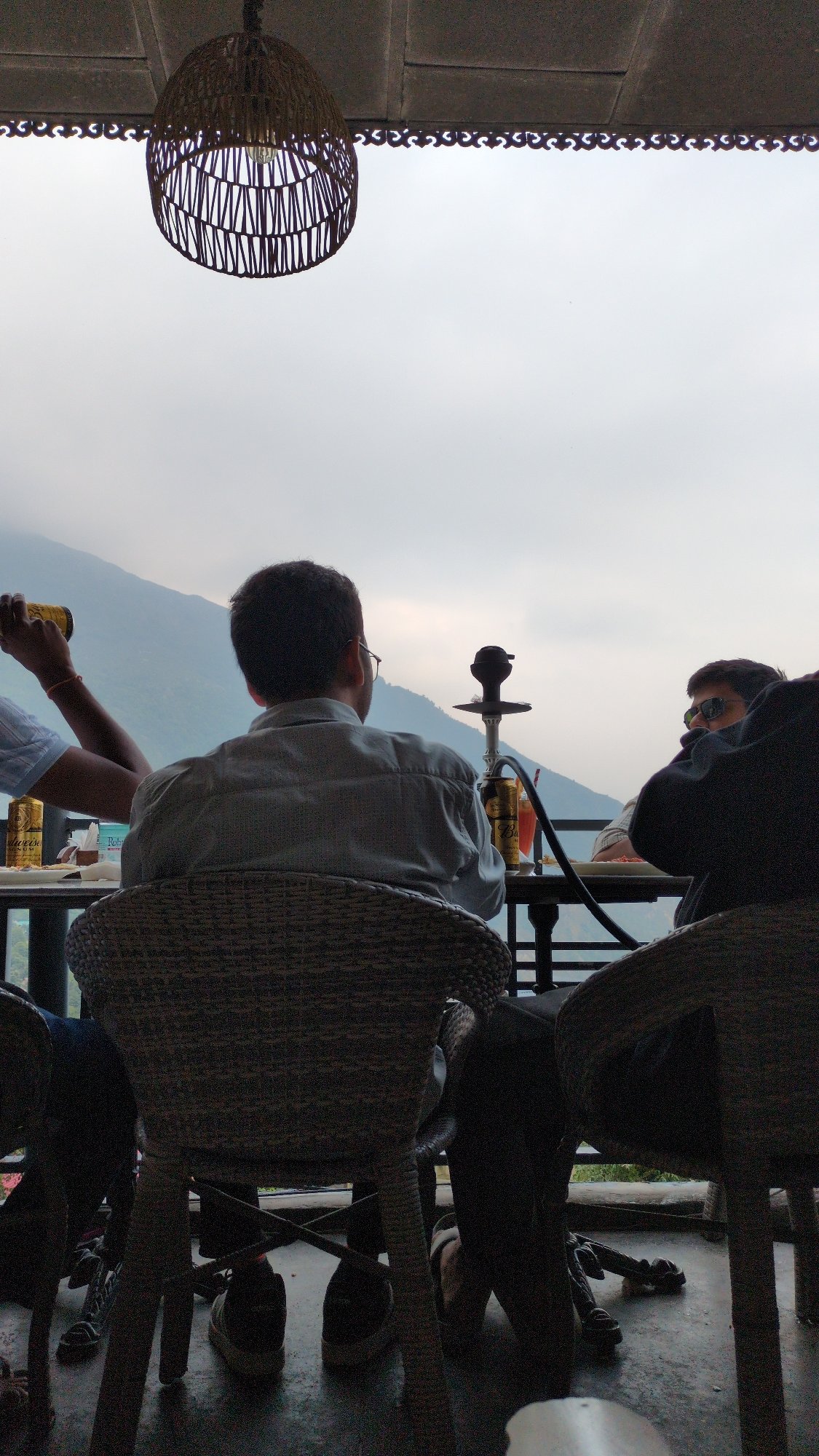 Friends share casual lunch and hookah in Dharamkot cafe