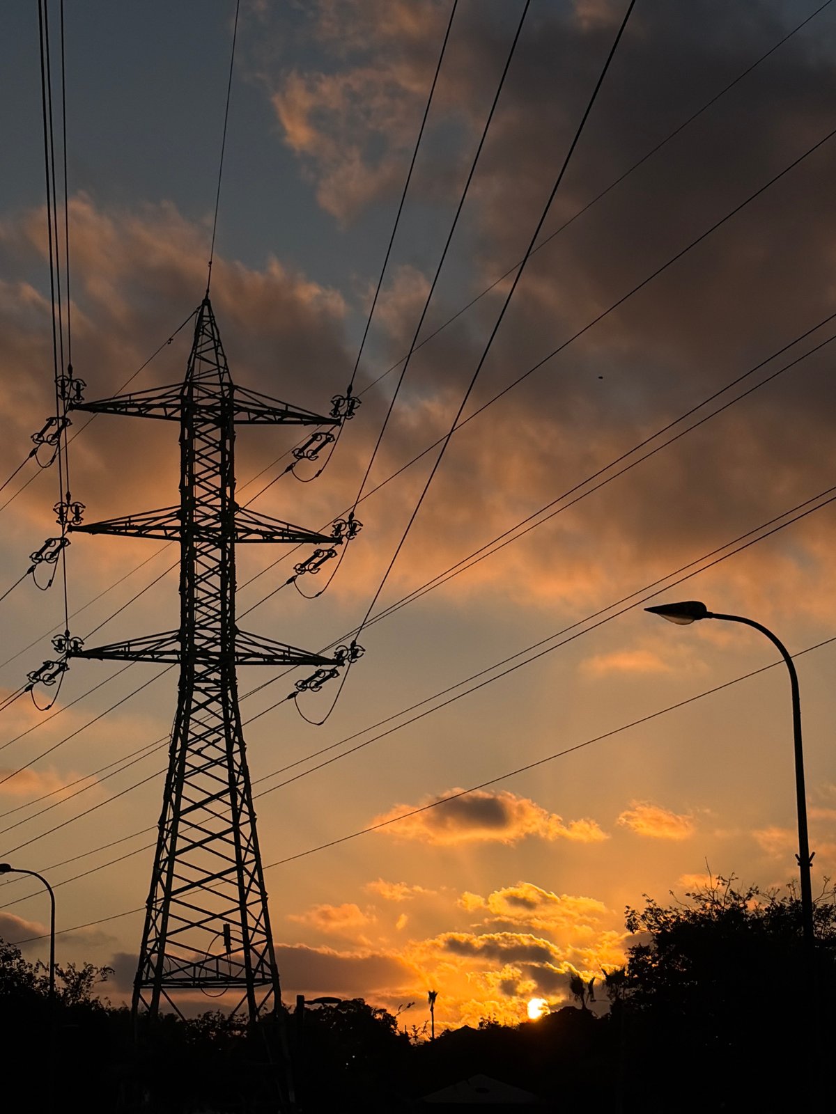Tel Aviv sky at dusk: pylons, traffic lights, and a crescent moon