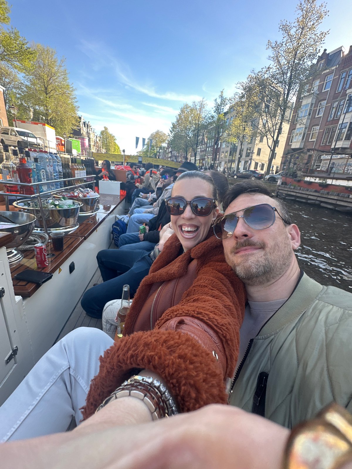 Canal boat tours operate in sunny Amsterdam afternoon