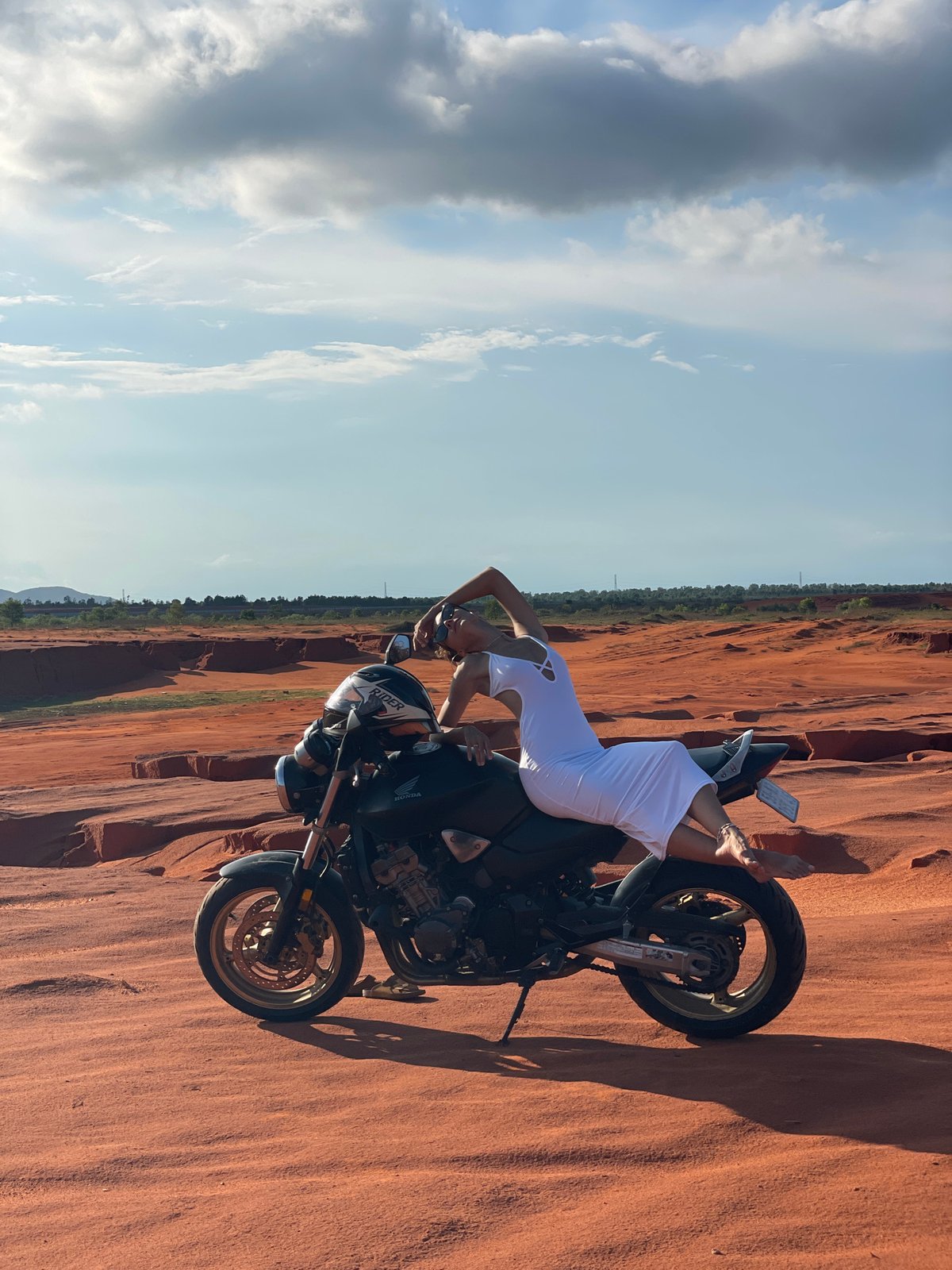 Woman poses with motorcycle in Mui Ne sand dunes