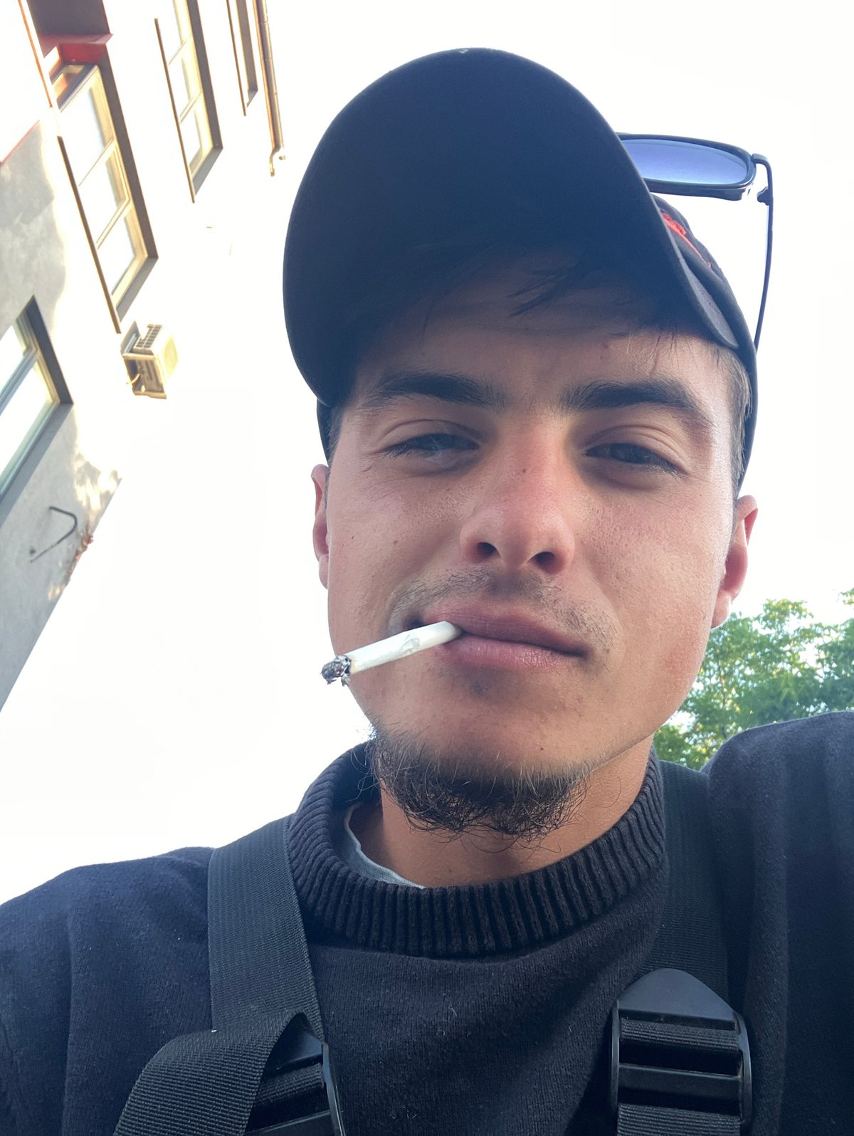 Young man photographed smoking on rainy Plovdiv streets