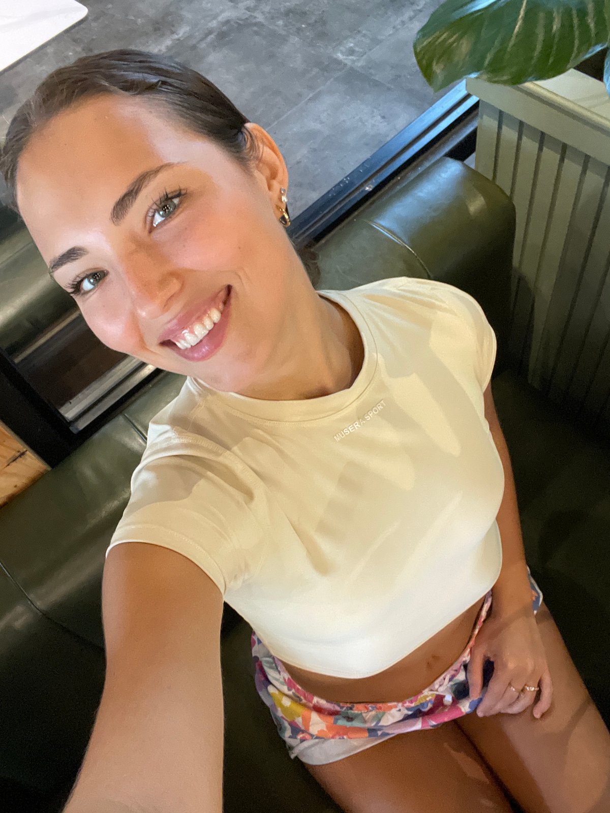 Woman documents breakfast at rustic cafe with salmon salads