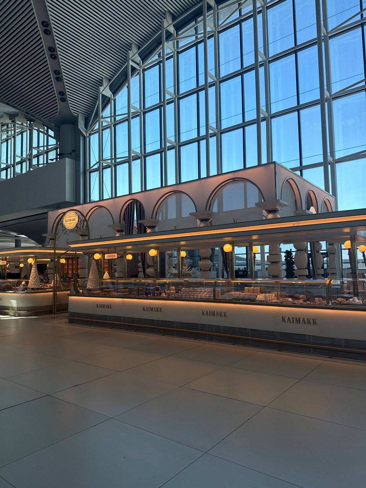 Moving through Istanbul Airport terminal with shopping bag in hand