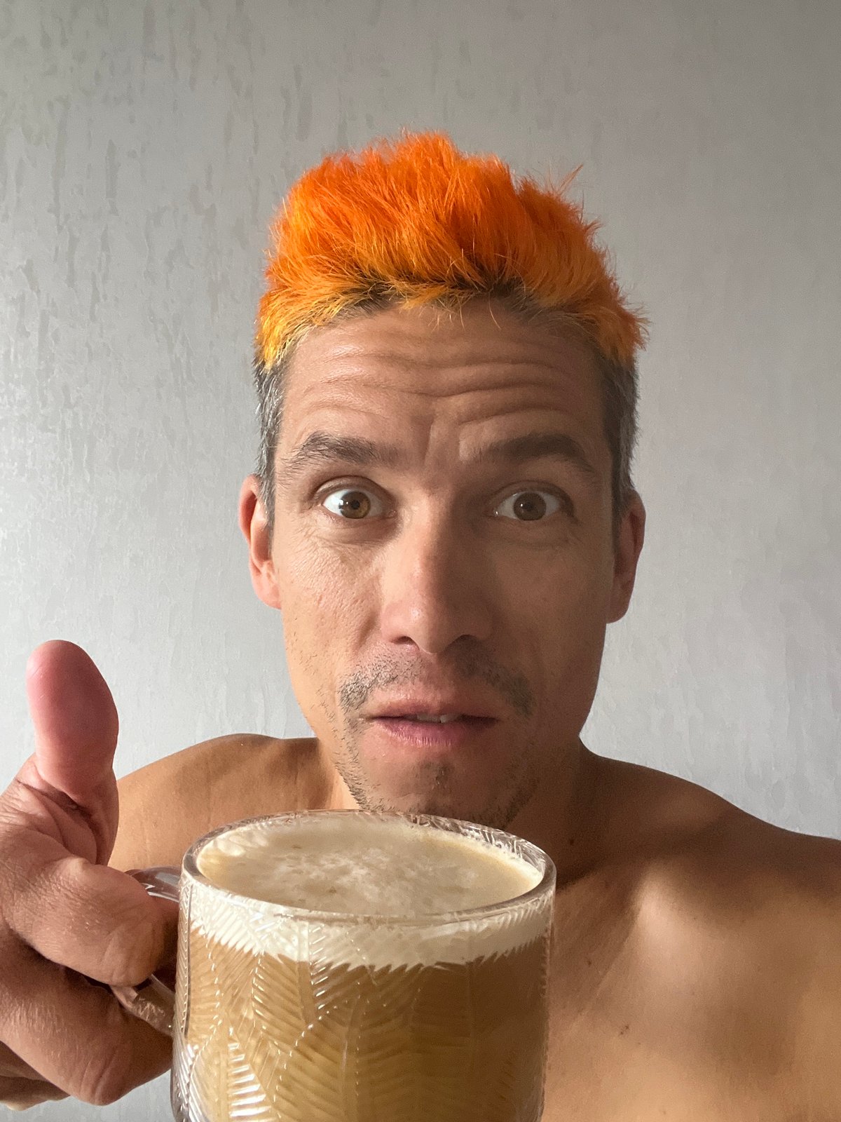 Orange-haired cyclist documents coffee break with cat in Chaikovsky