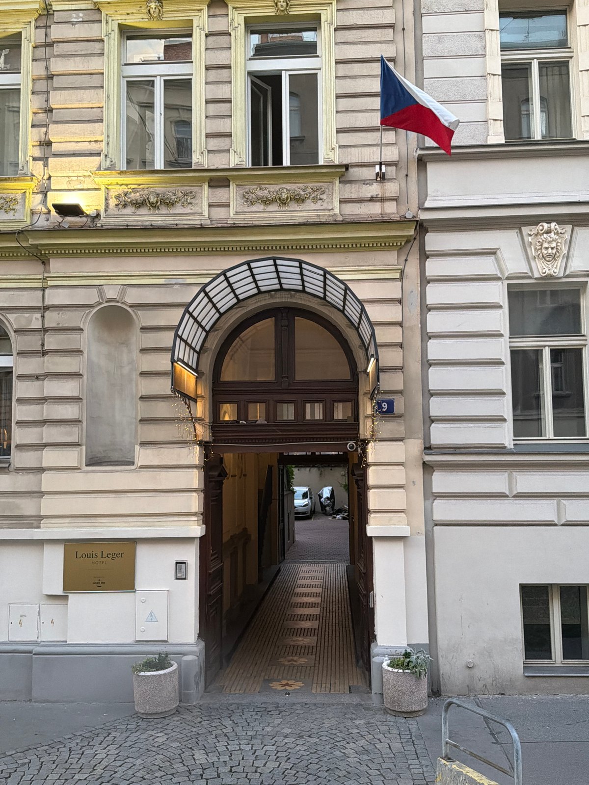 Louis Leger Hotel entrance, Prague historic building with Czech flag