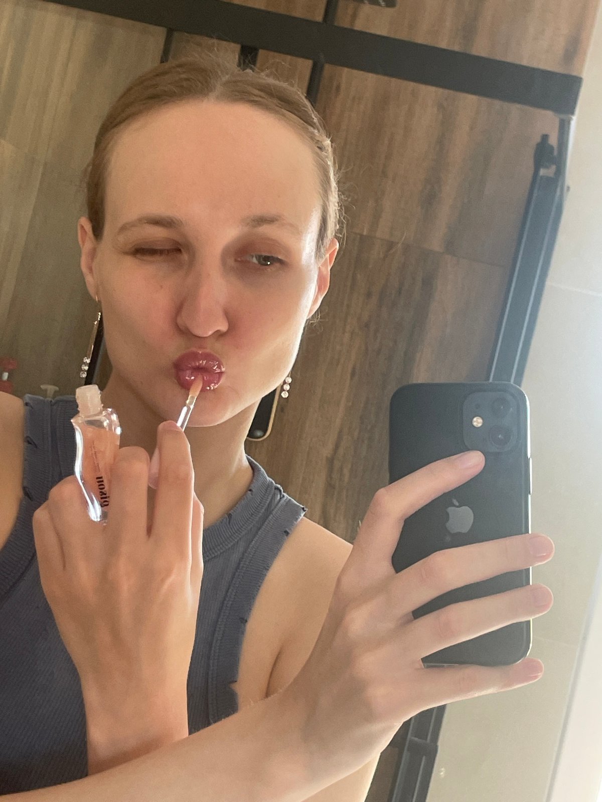 Woman Takes Selfie While Applying Lip Gloss in Russia