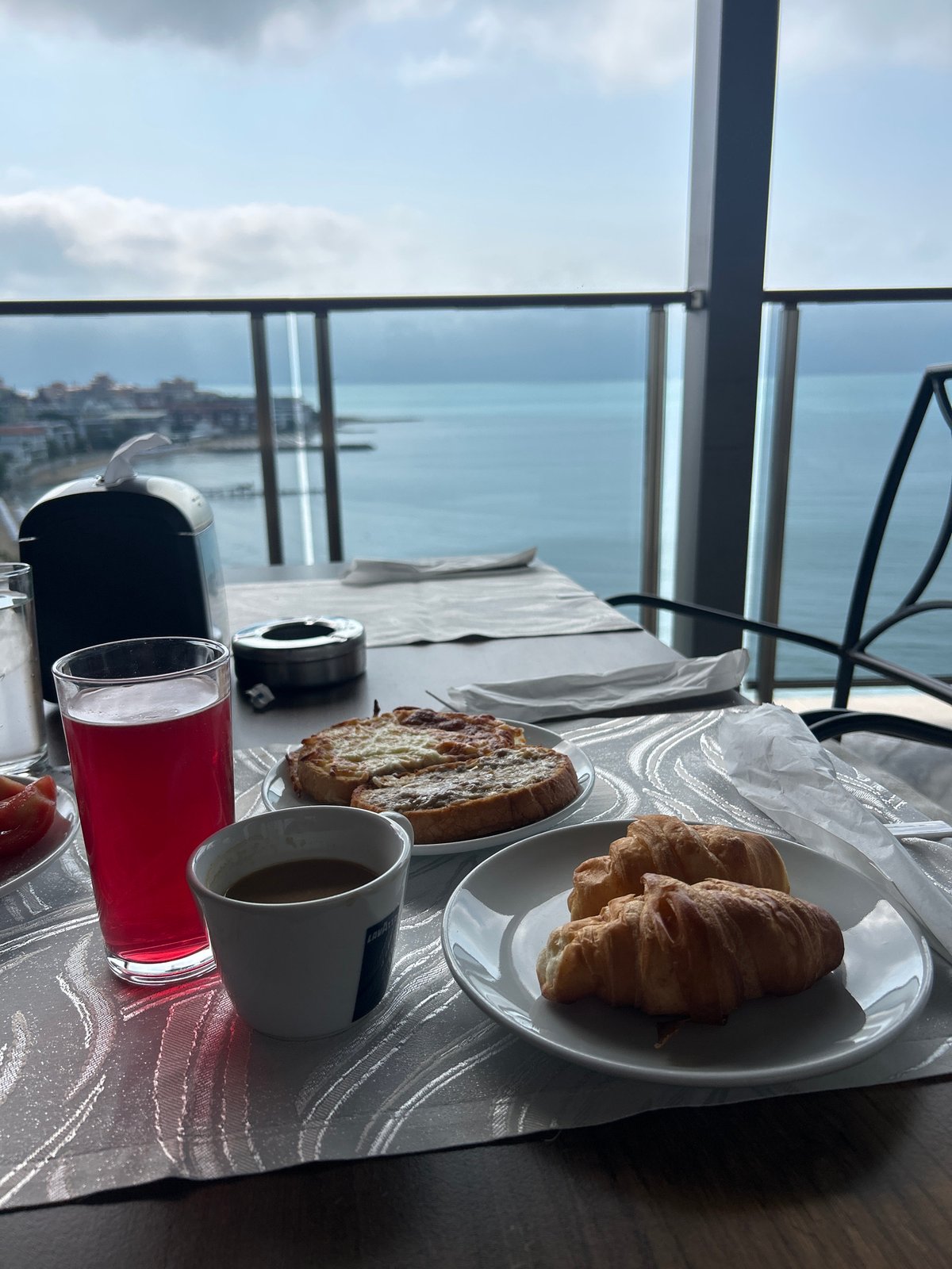 Morning breakfast setup captured with seaside panoramic view