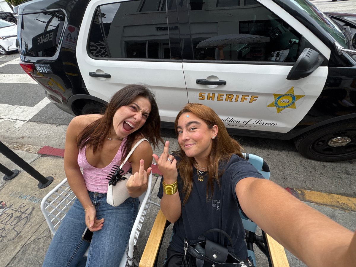 Woman grimaces at outdoor table in Los Angeles
