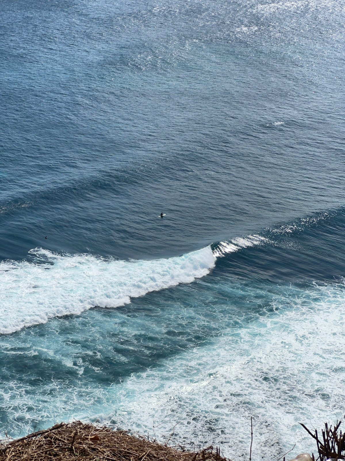 Surfers and cliff views at a Kuta Selatan coastal lookout