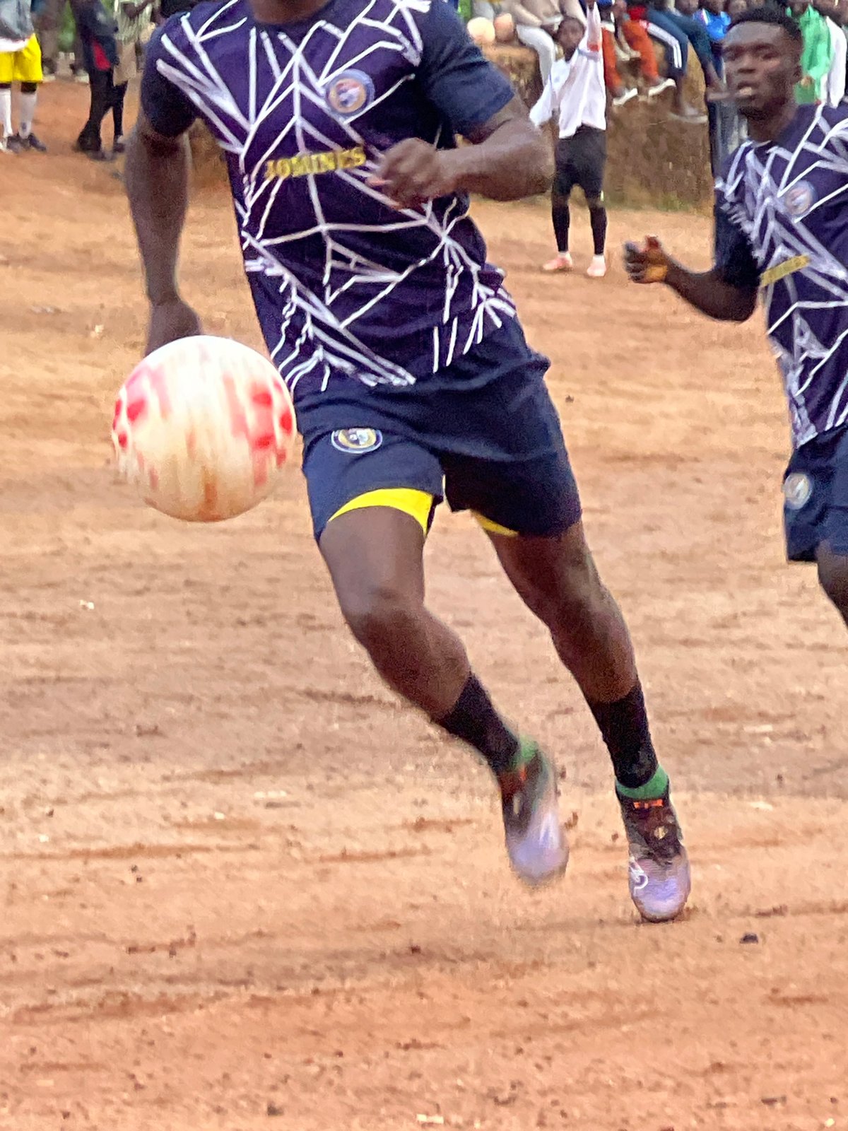 Pickup soccer match on a dirt field in Jos, Nigeria