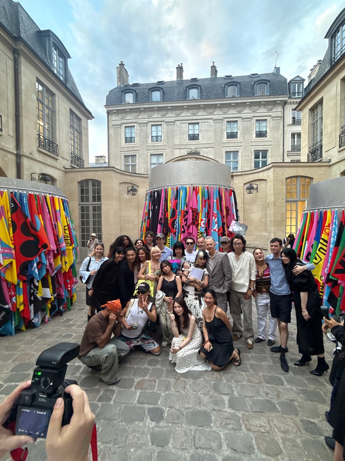 Group photo and selfie moment in a Paris courtyard