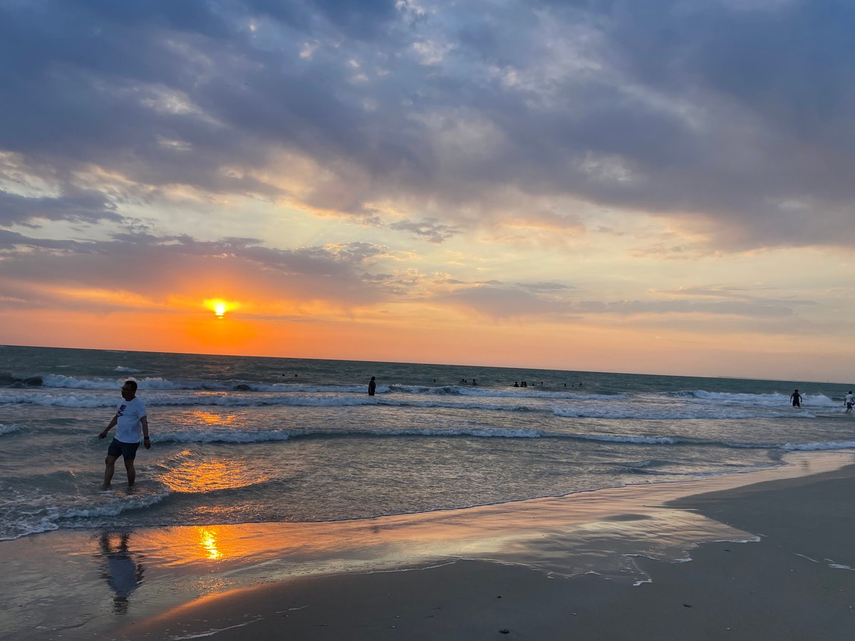 Golden hour at a Kazakh beach, waves rolling in at sunset