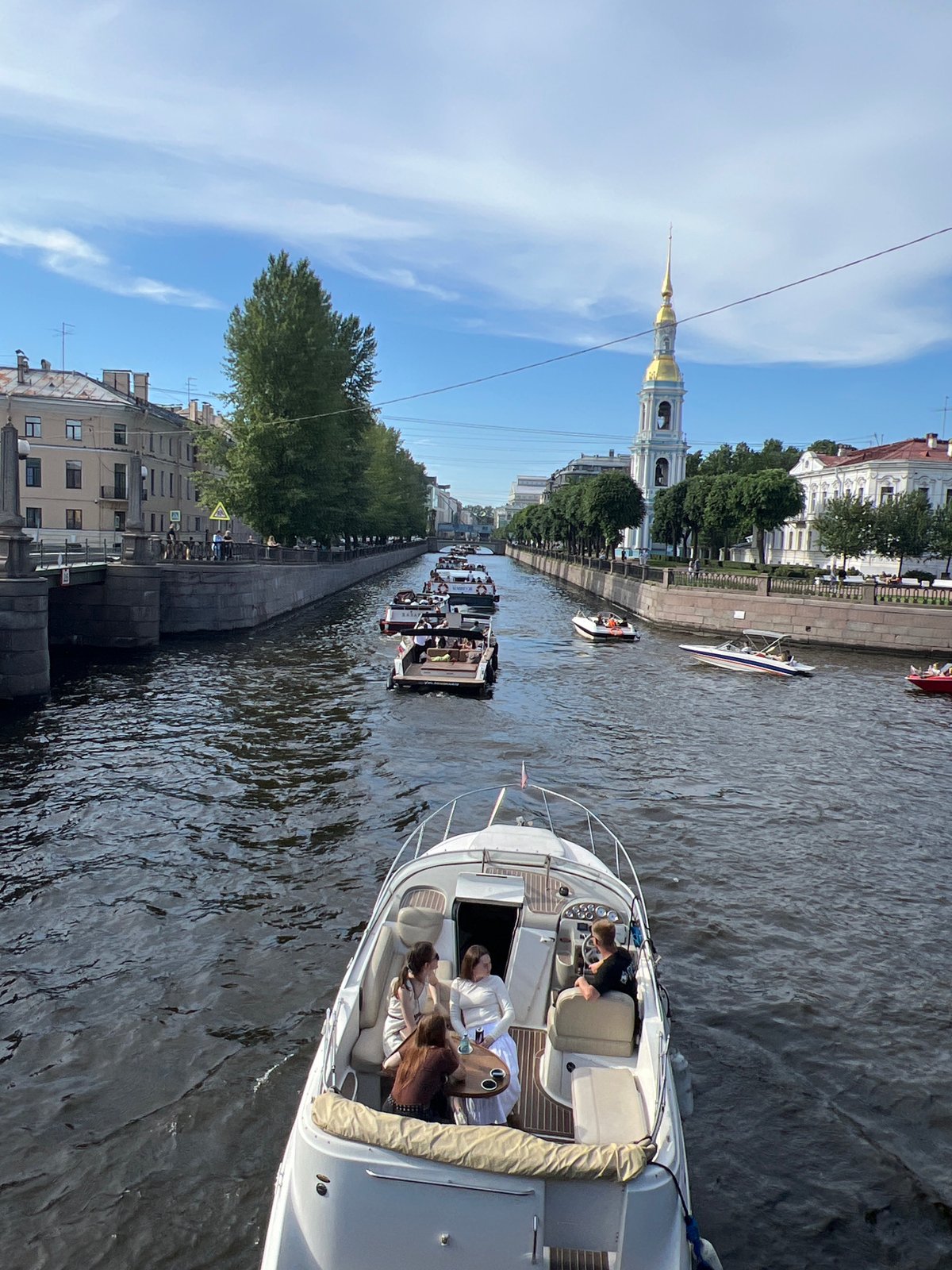 Afternoon boat traffic on Saint Petersburg's sunny canals