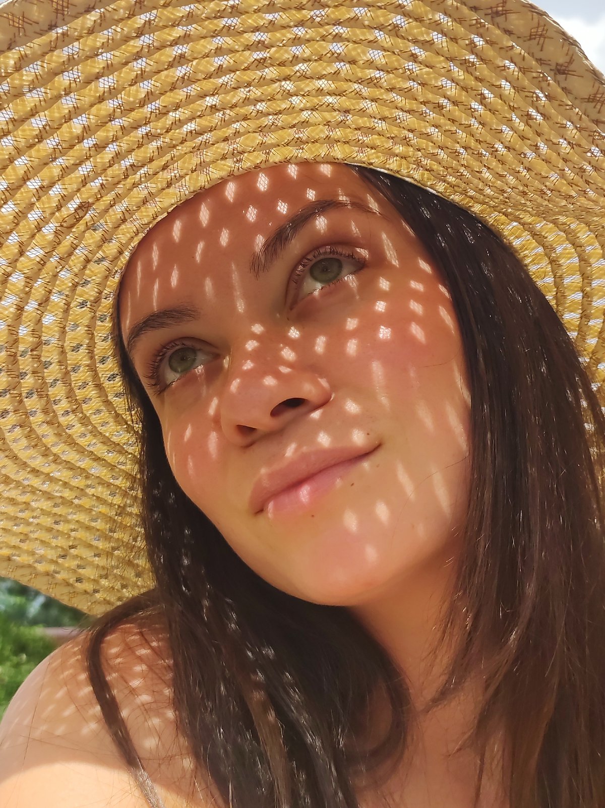 Straw hat, summer fruit, and dappled light in Fokino