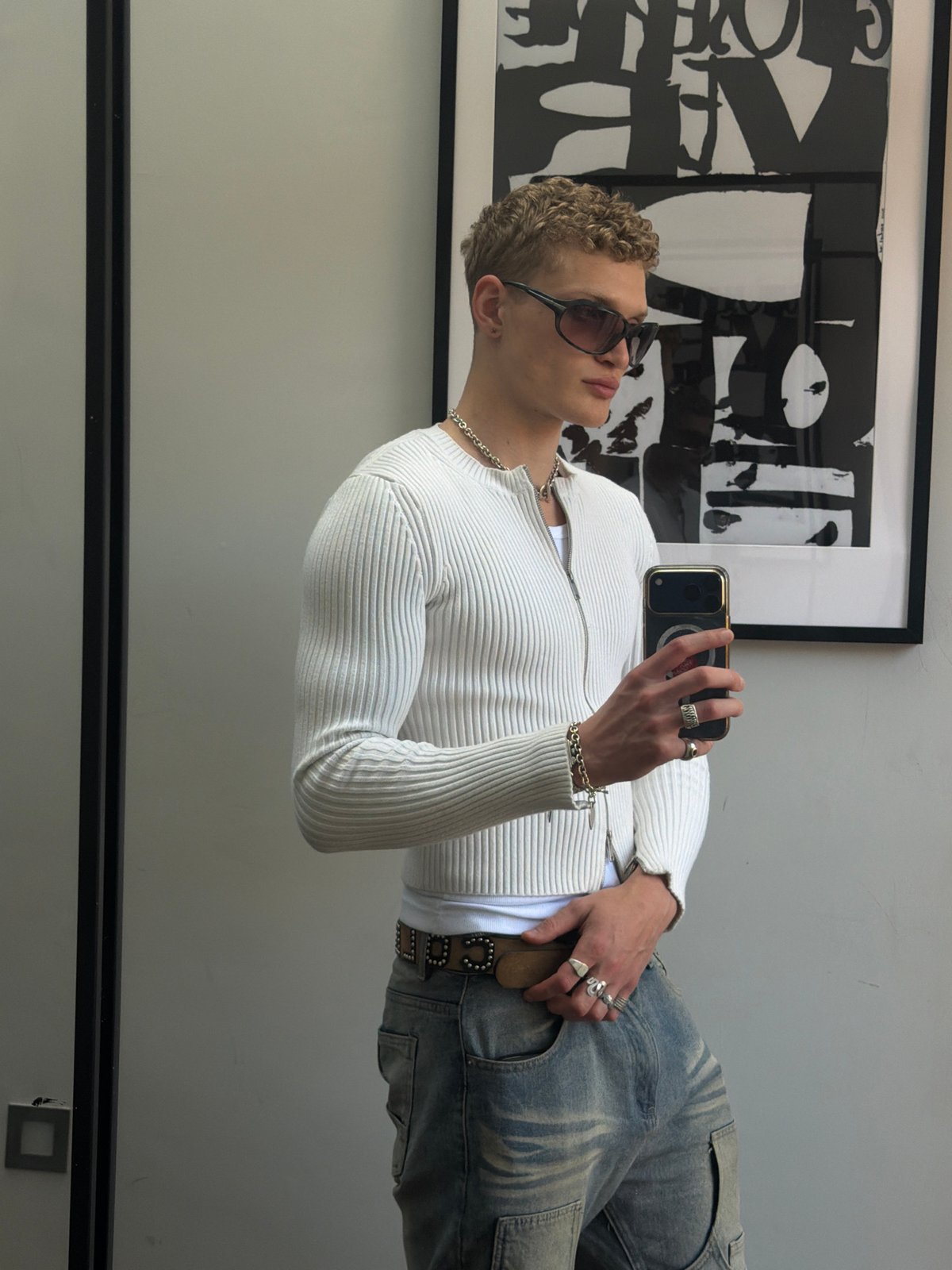 Person takes mirror selfies in white cardigan in London