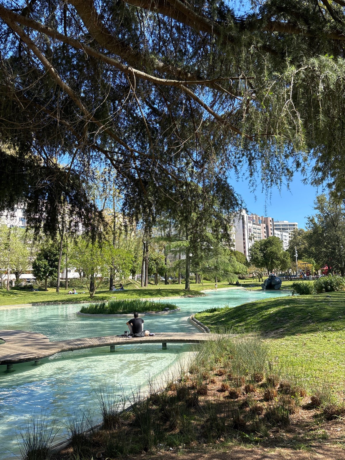 Visitors document scenic water features at Lisbon's Parque Eduardo VII
