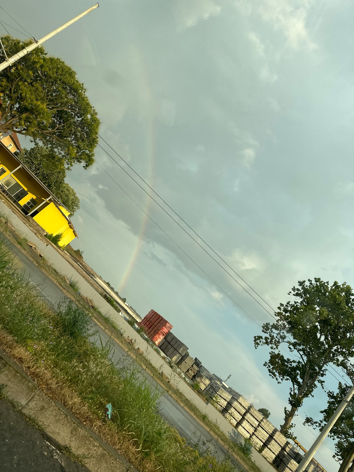 Wet streets and a faint rainbow in post-rain Ruse