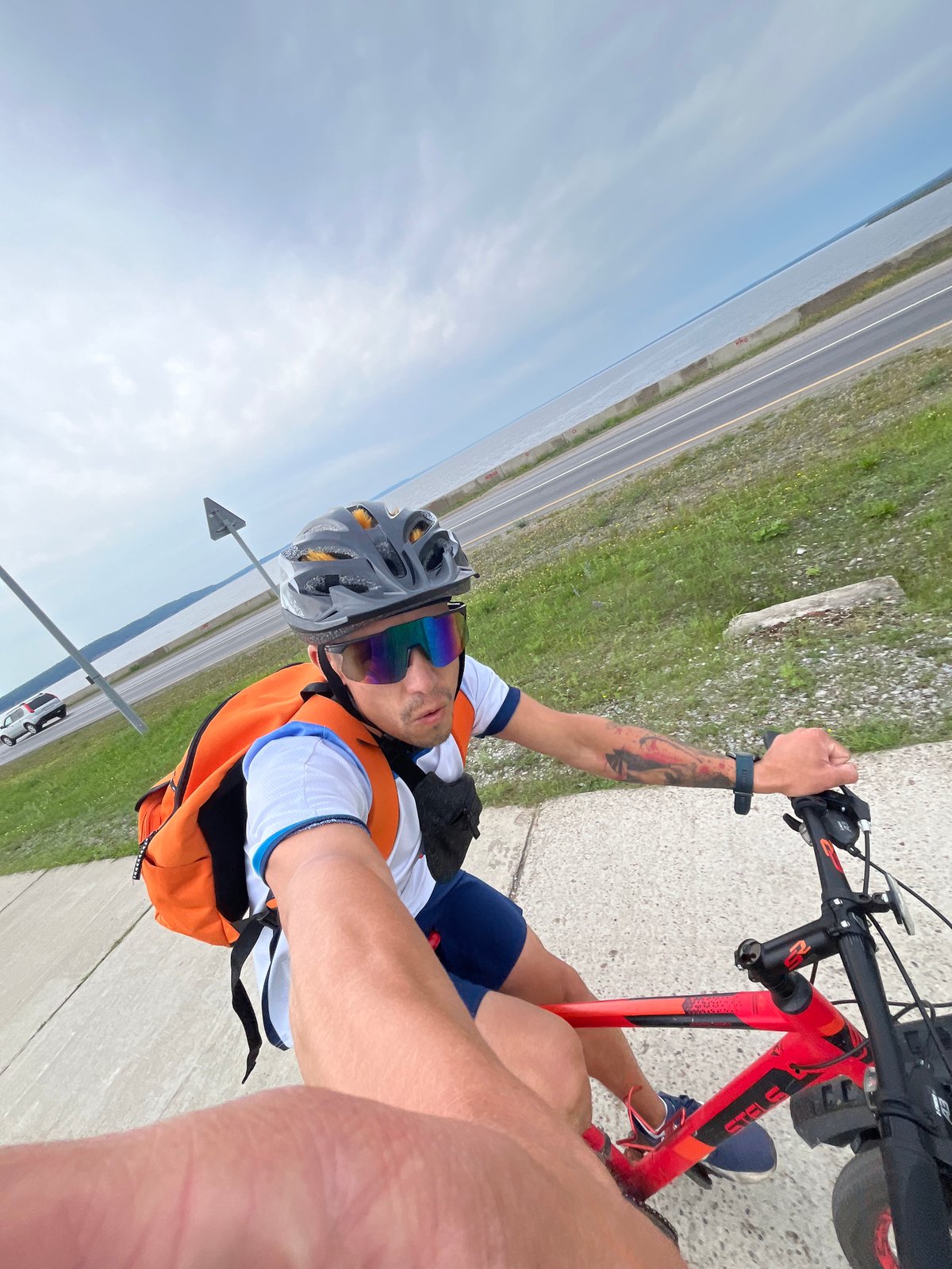 Red bicycle ride along a riverside path in Chaikovsky