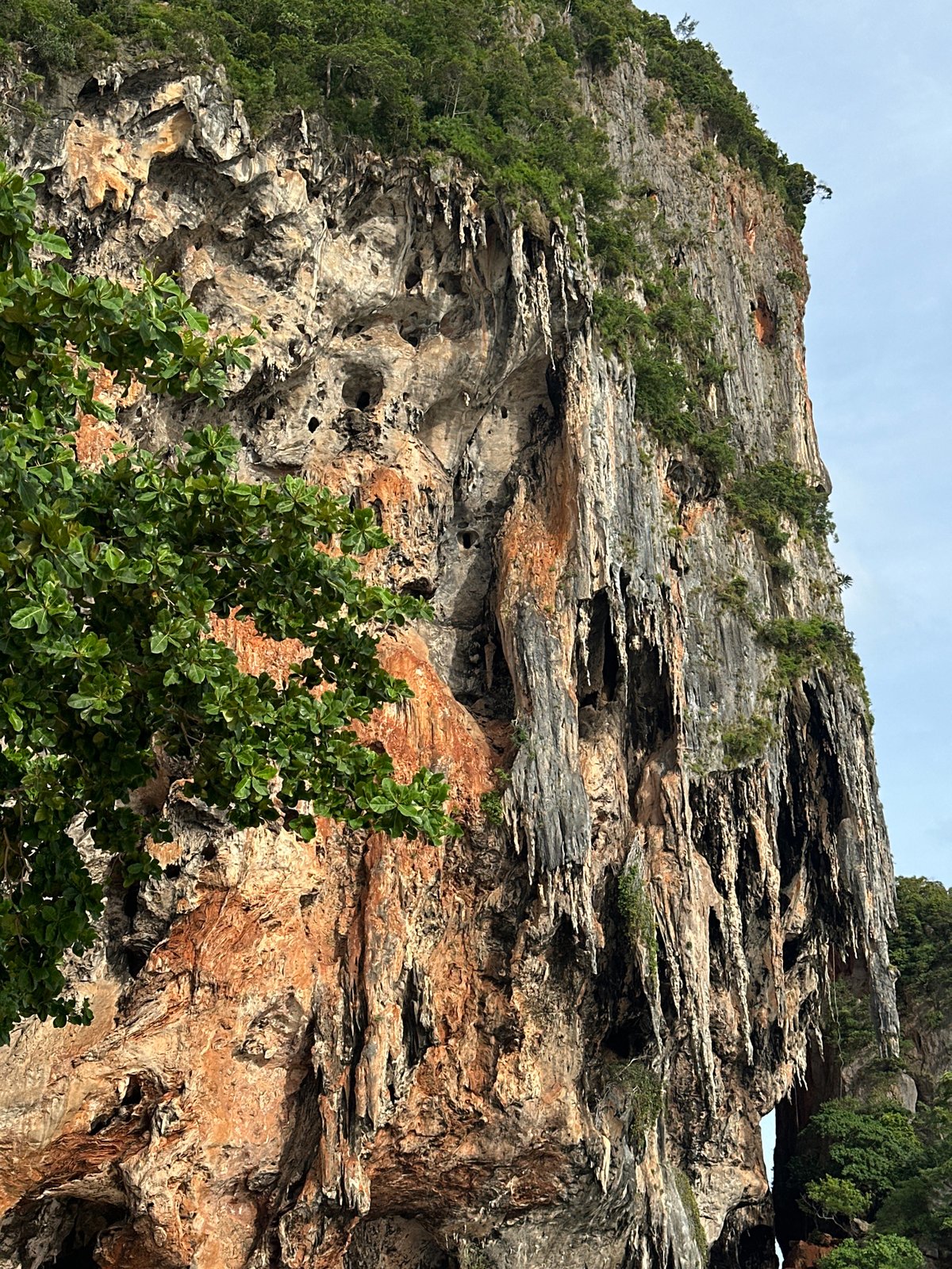 Limestone cliffs tower over Ban Ao Nang's beach and buildings