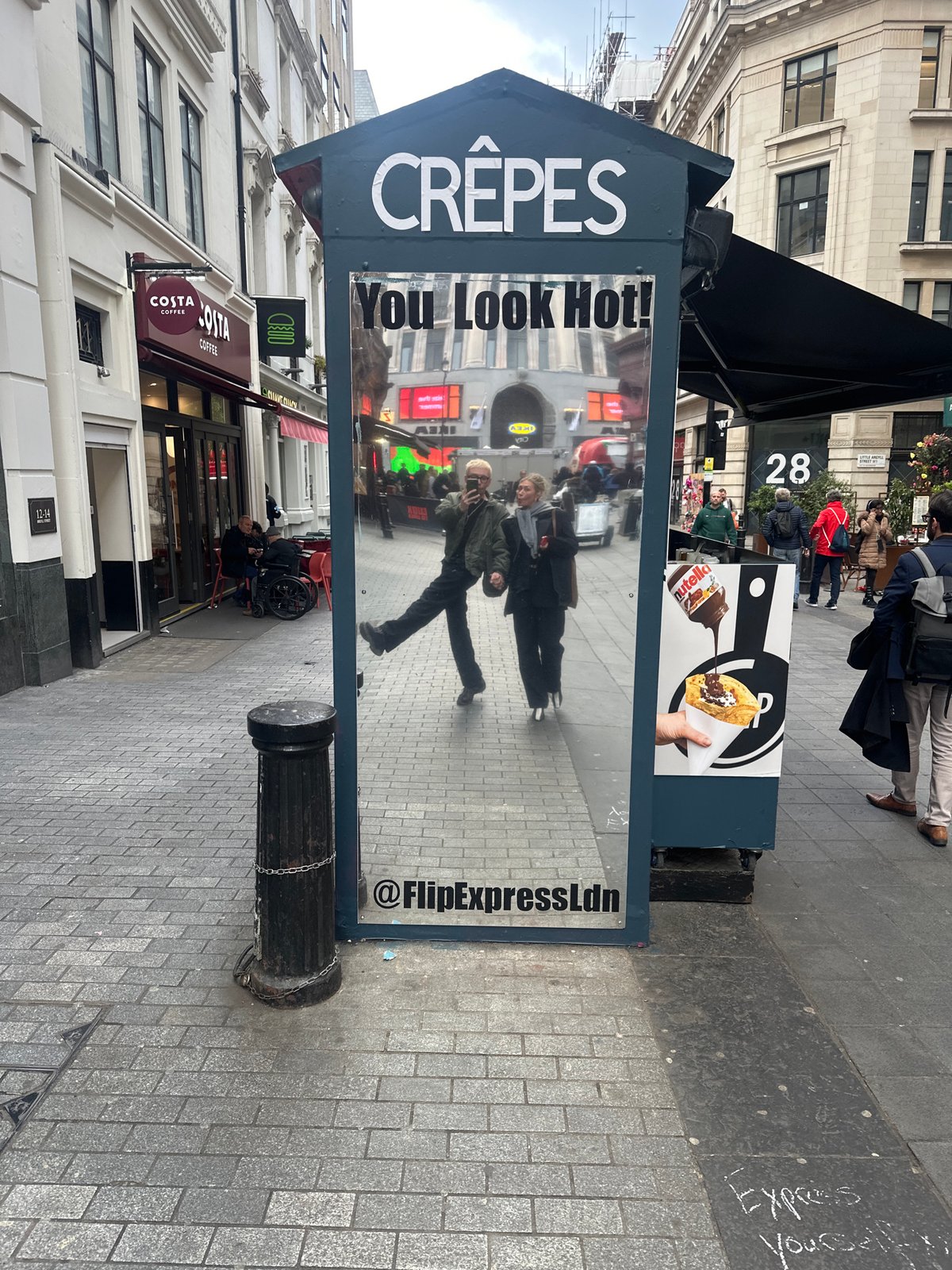 London crêpe vendor displays flirty "You Look Hot!" sign