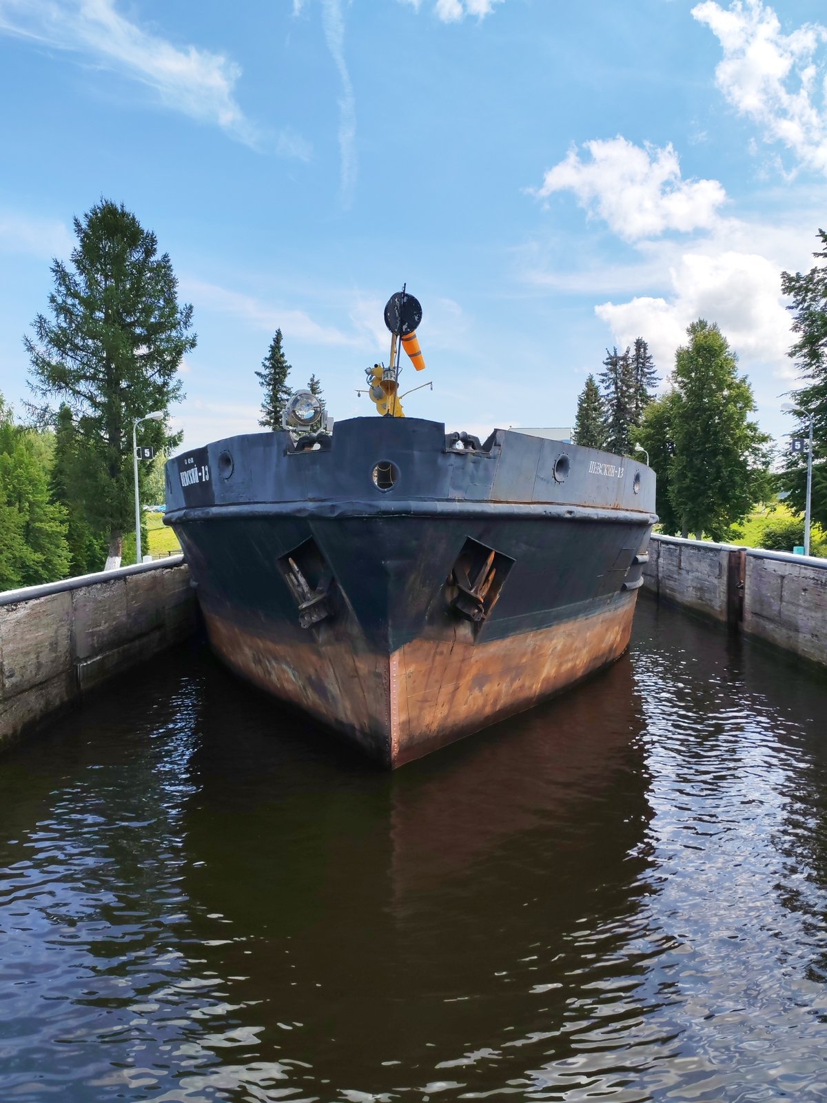 Barge passing through canal lock at Belousovo, Russia