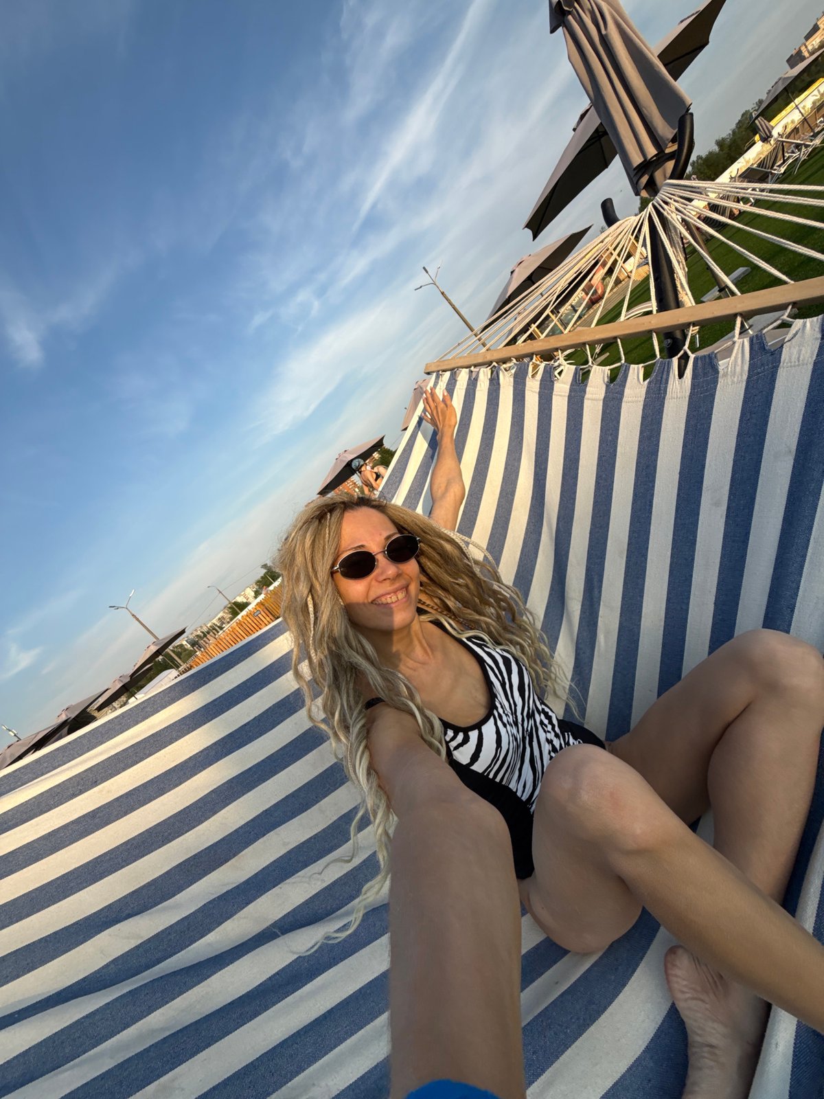 Woman sunbathes at outdoor leisure facility in Шебунино, Russia