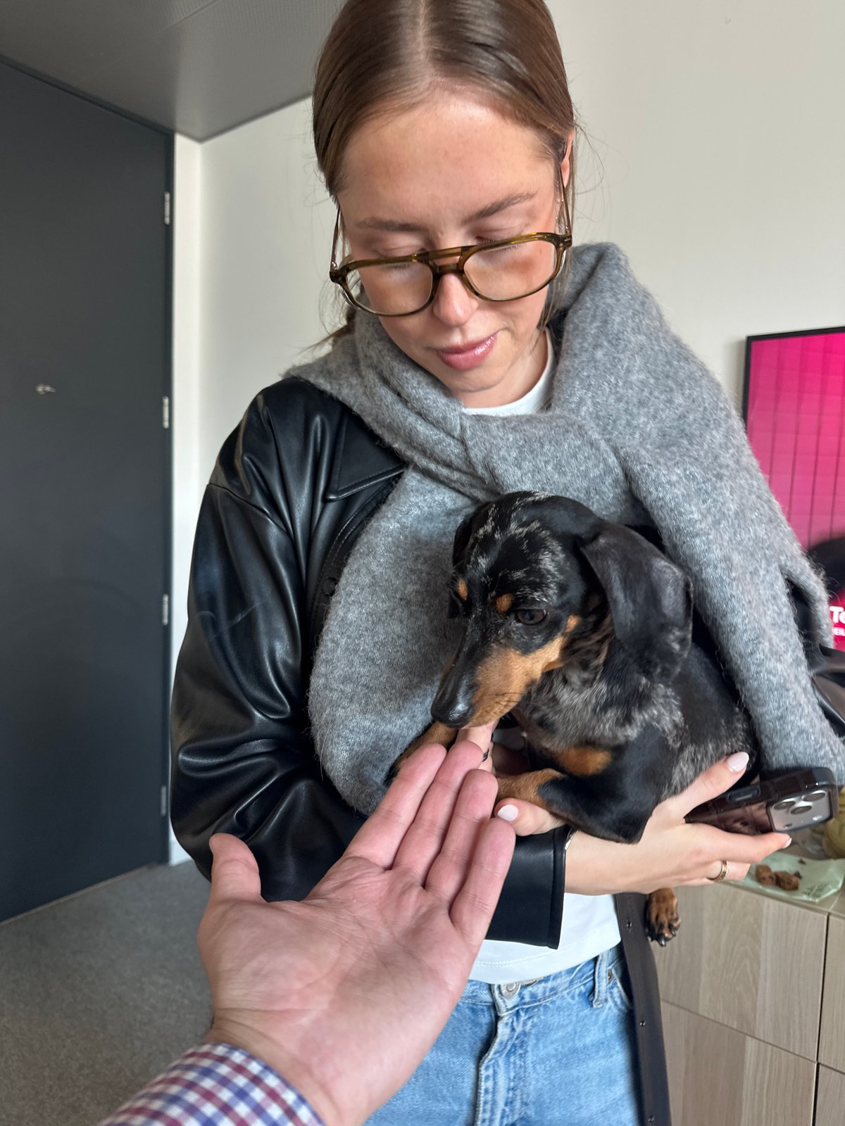 Woman with dachshund dog spotted in London indoor setting