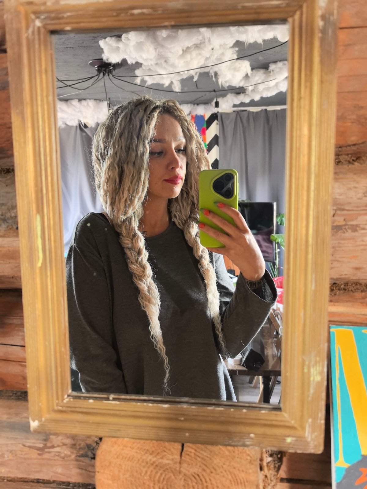 Woman takes mirror selfie with green phone in Russia