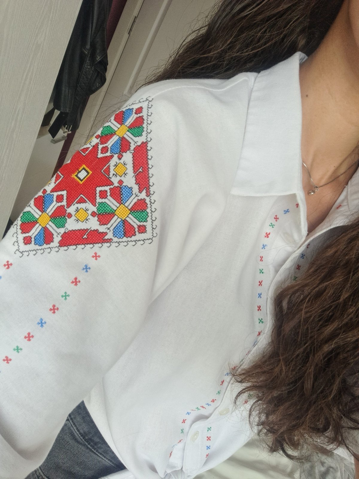 Woman poses with math notes in embroidered shirt