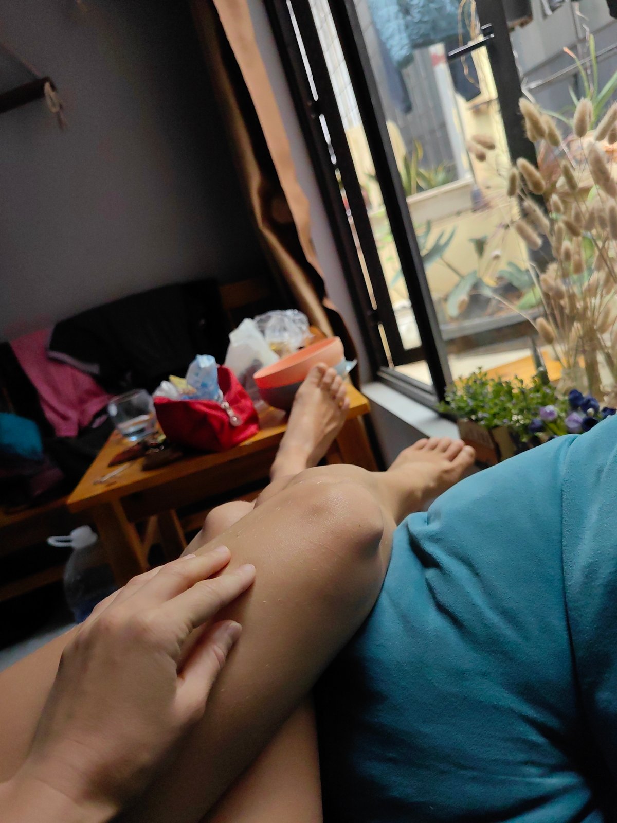 Person in blue shirt sits indoors in Hà Nội
