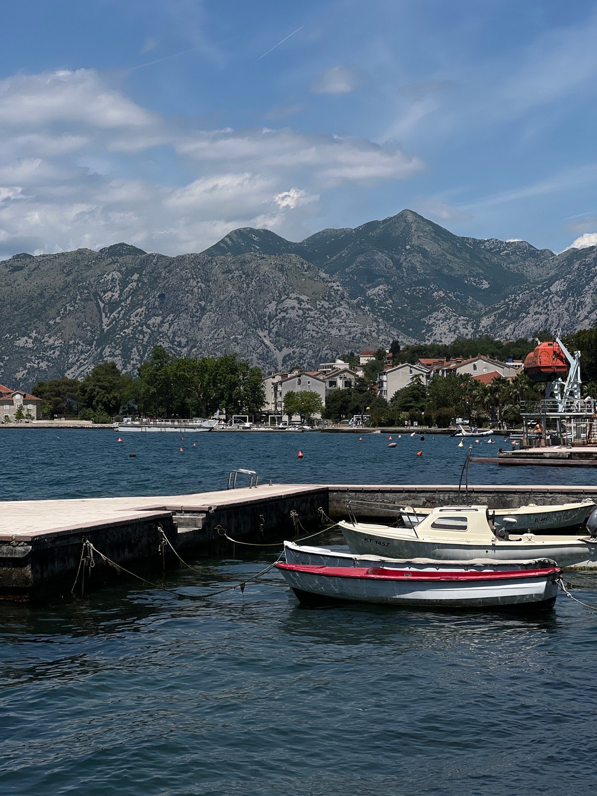 Tourist photographs coastal scenery in Dobrota, Montenegro