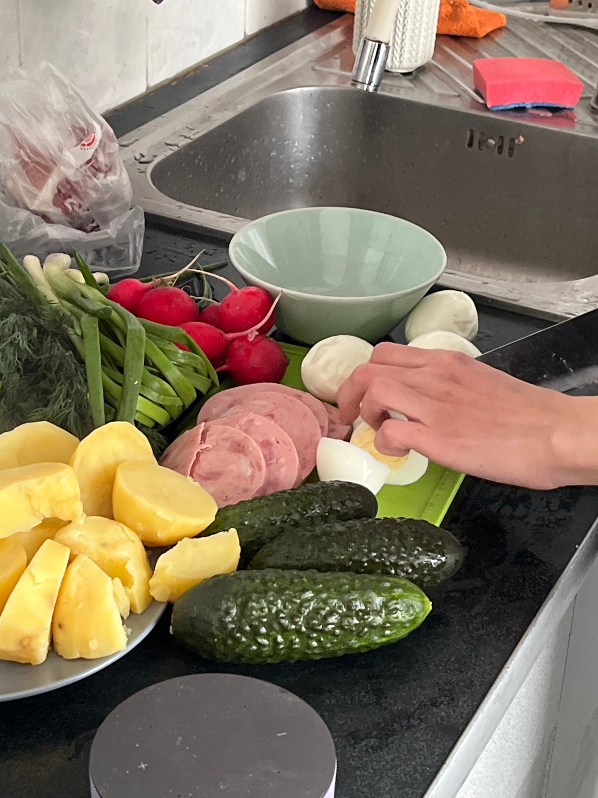 Kitchen food prep documented with salad ingredients, anomalous artwork