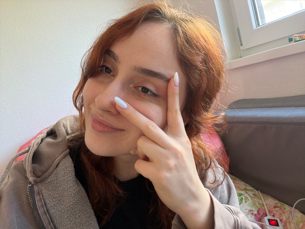 Woman takes playful selfies indoors in Strasbourg
