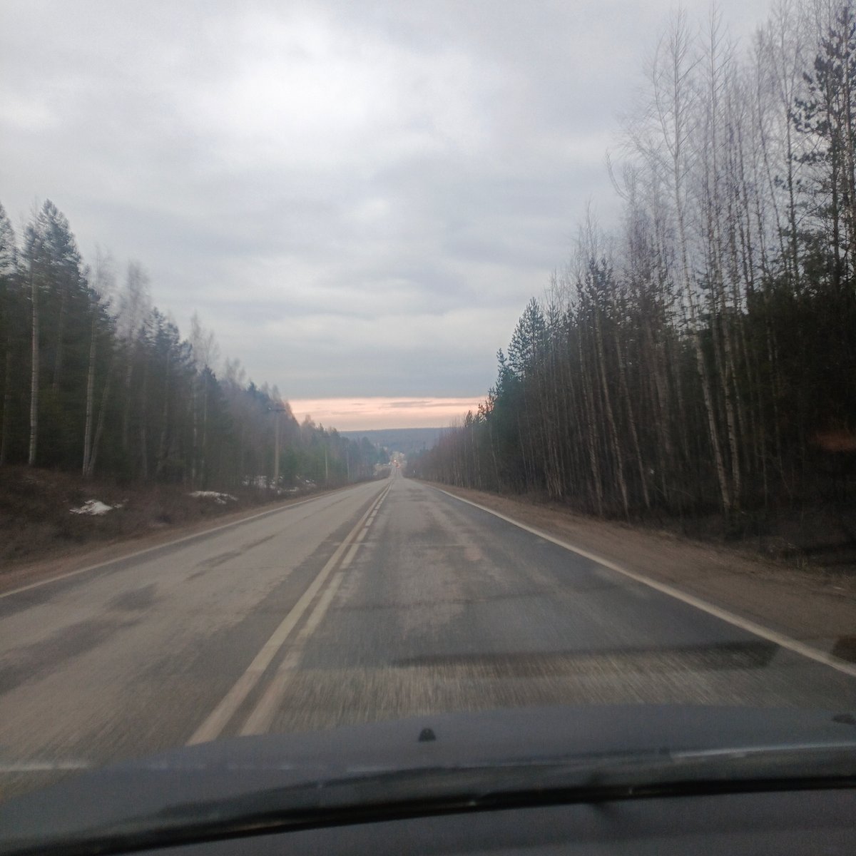 Overcast afternoon captured on forested road in Chaikovsky, Russia