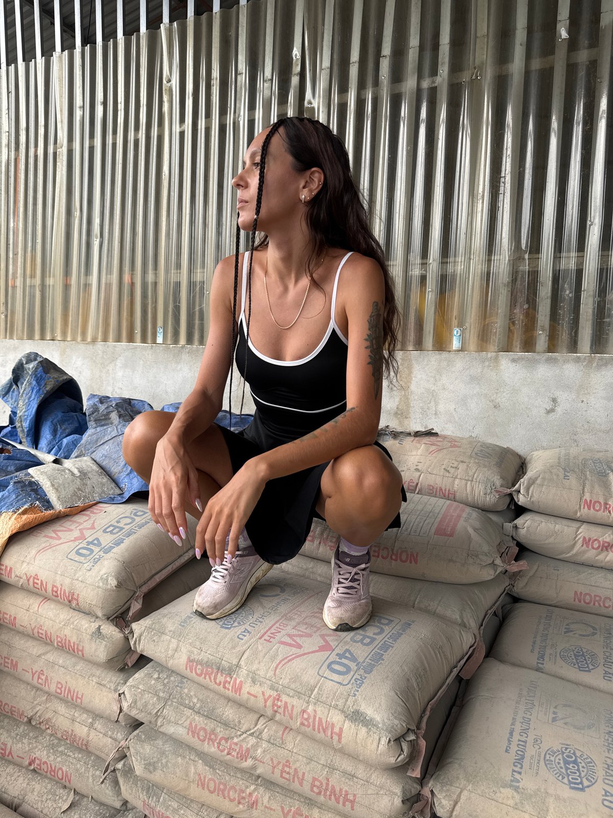 Casual moments documented near bridge and construction materials in Vietnam