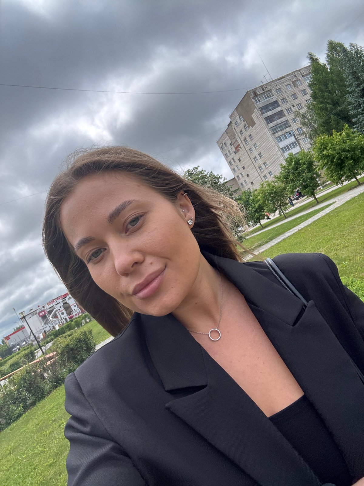 Woman takes selfies outdoors in Chernushka during morning photo session