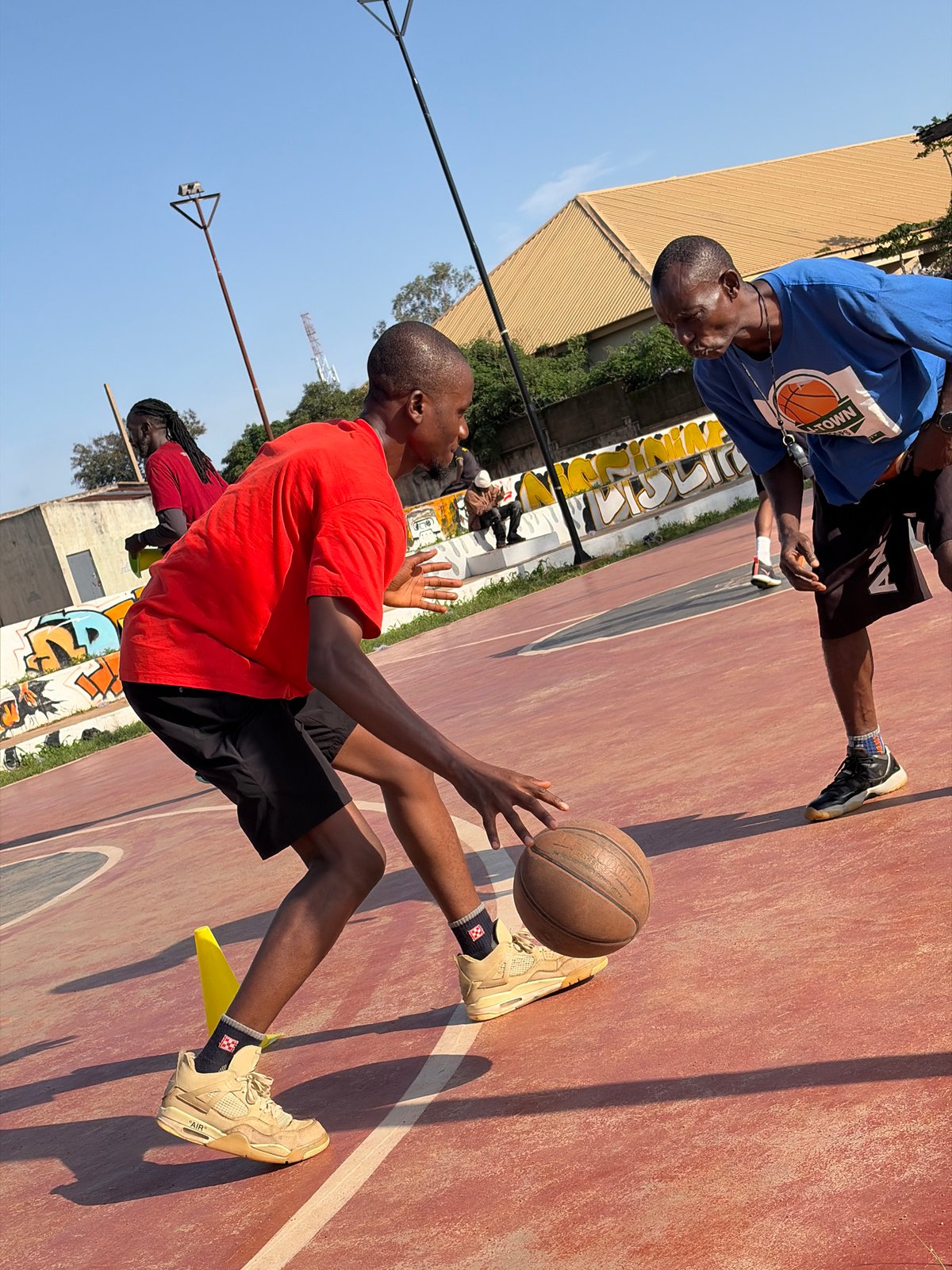 Morning basketball drills at an outdoor court in Jos, Nigeria