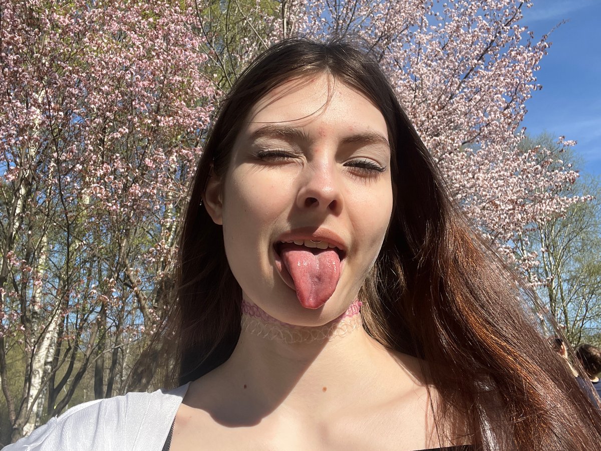 Woman photographs cherry blossoms in St. Petersburg park