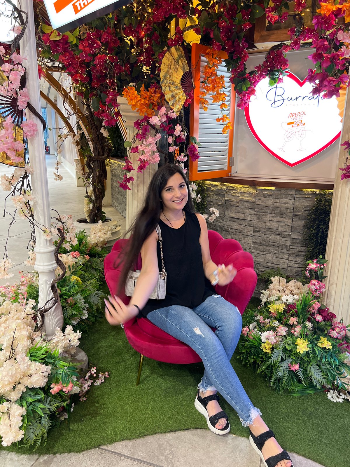 Pink armchair photo spot with florals and neon hearts, Sofia