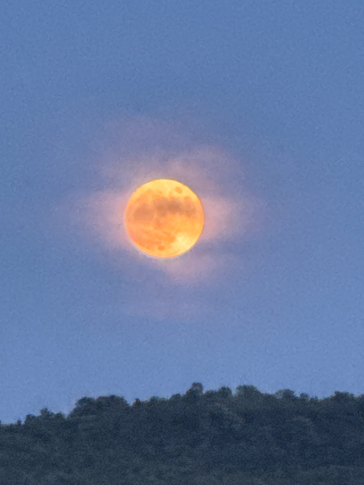 Full moon observed through clouds in Strazhitsa, Bulgaria