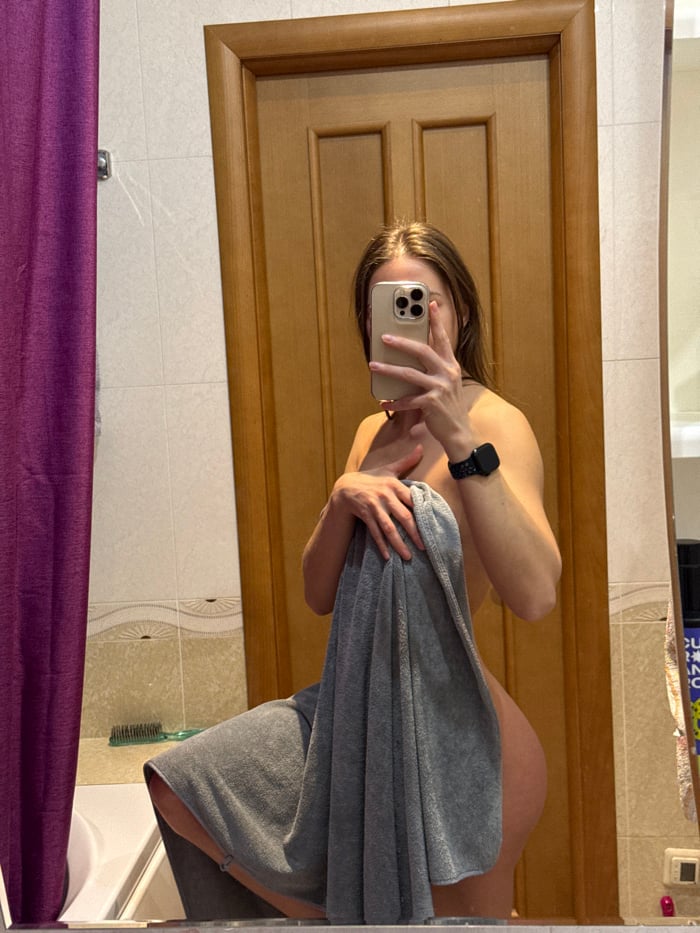 Person takes bathroom mirror selfies in Saint Petersburg apartment