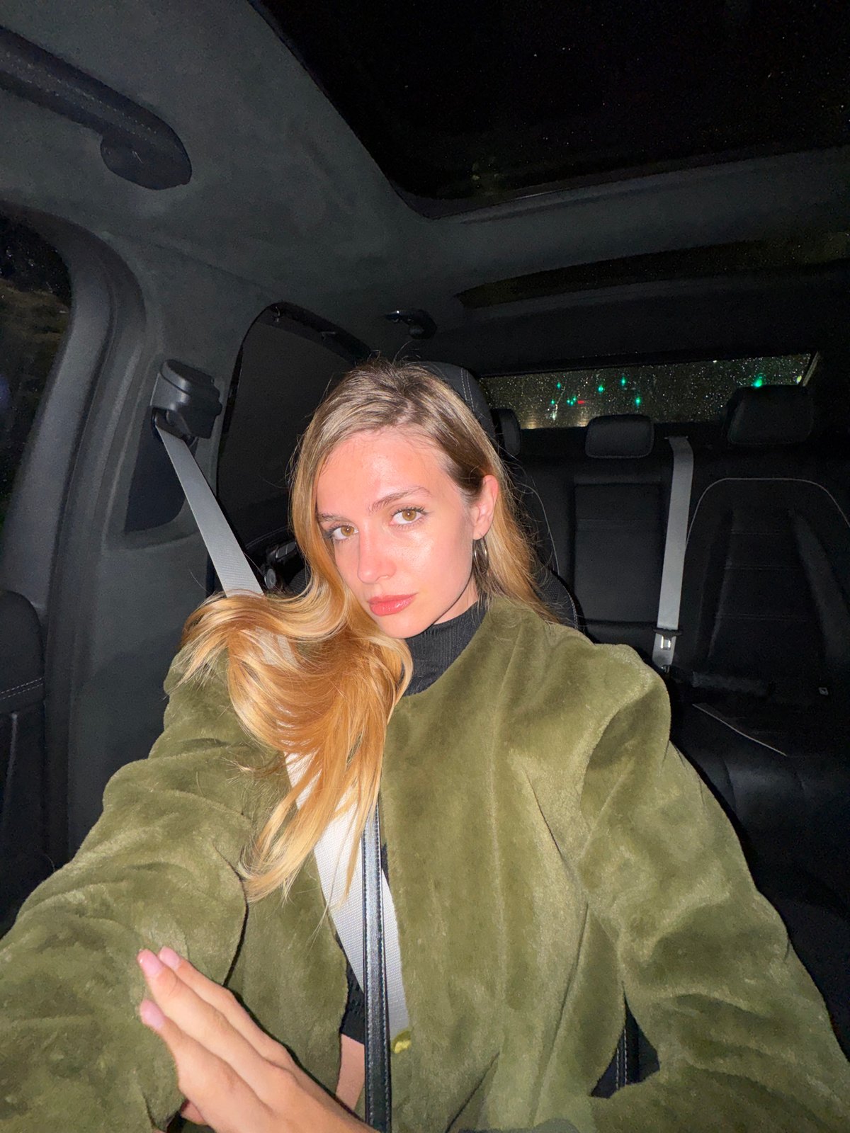 Woman photographed in car backseat in Tbilisi at night