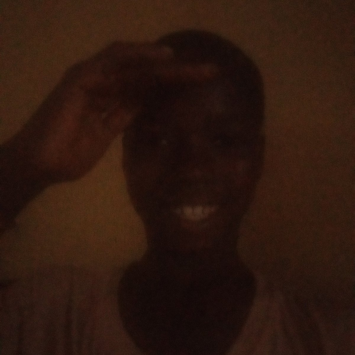 Resident documents daily life in dimly lit Adankolo home