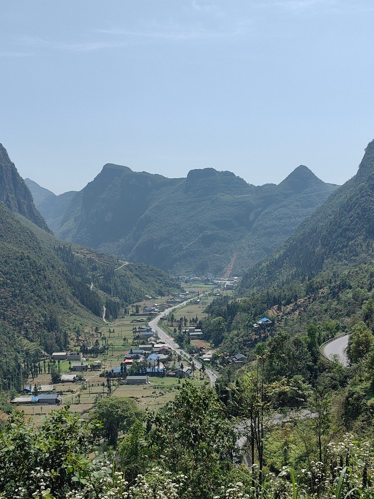 Motorcycle tourists stop for photos at Vietnam mountain overlook