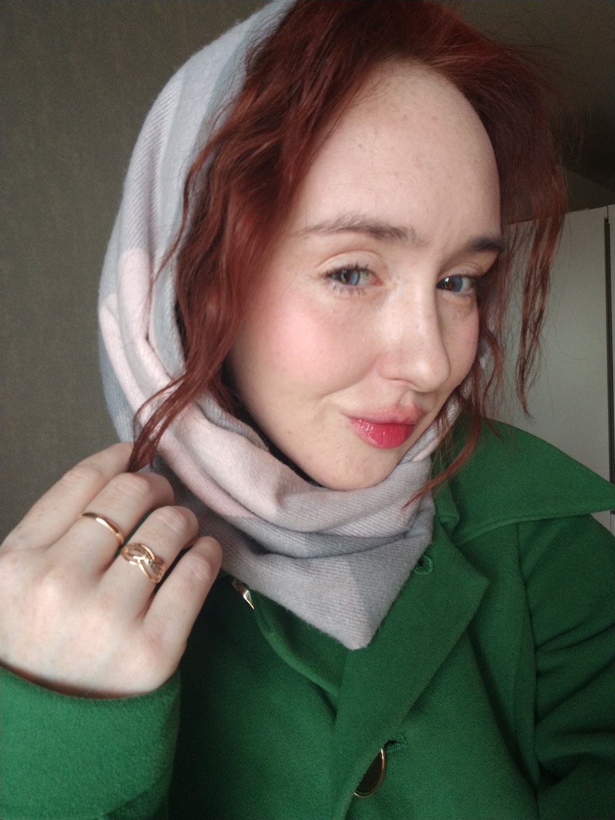 Woman in green coat photographed indoors in Izhevsk