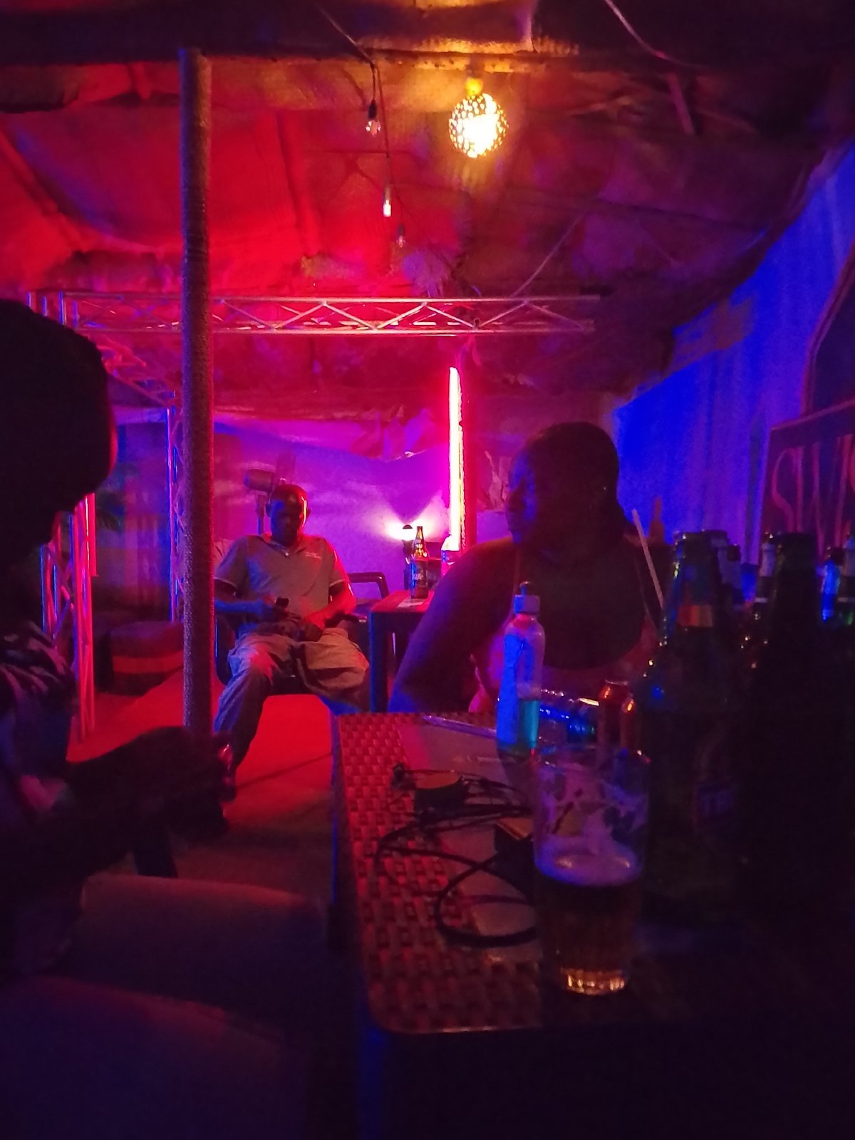 Interior space captured with colorful lighting and seated figure