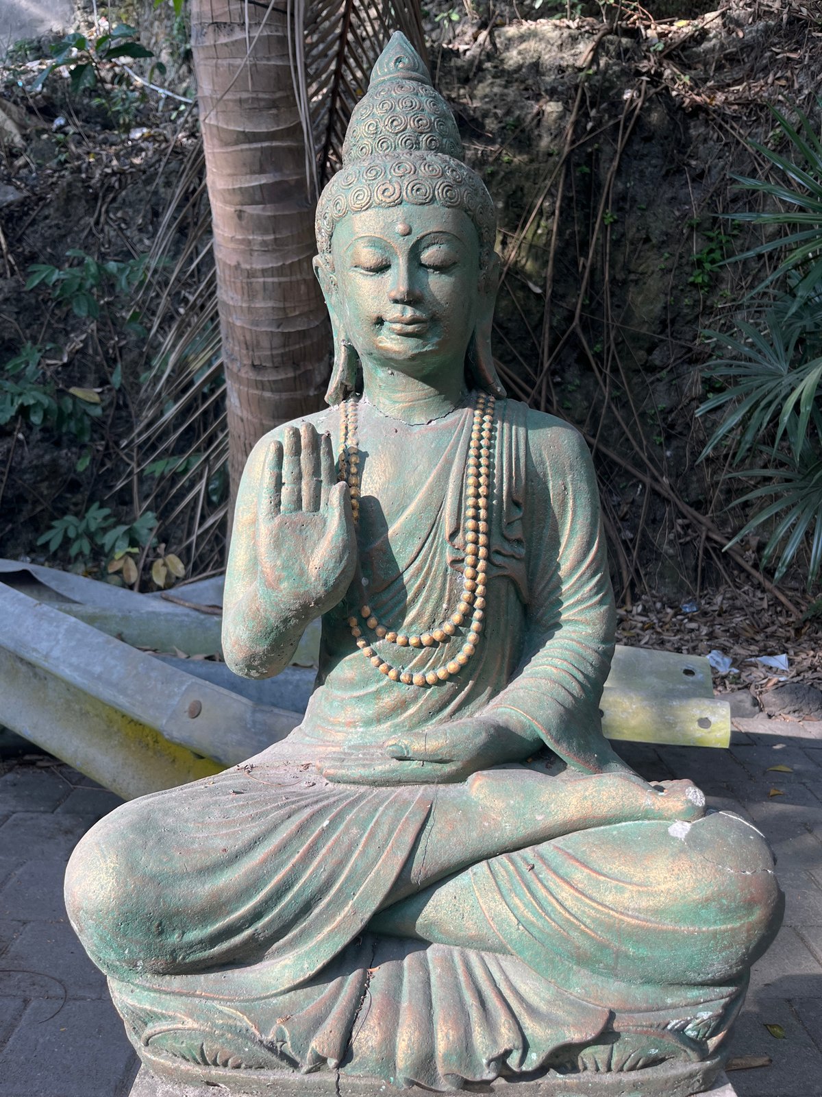 Weathered Buddhist sculptures documented at overgrown Kuta Selatan site