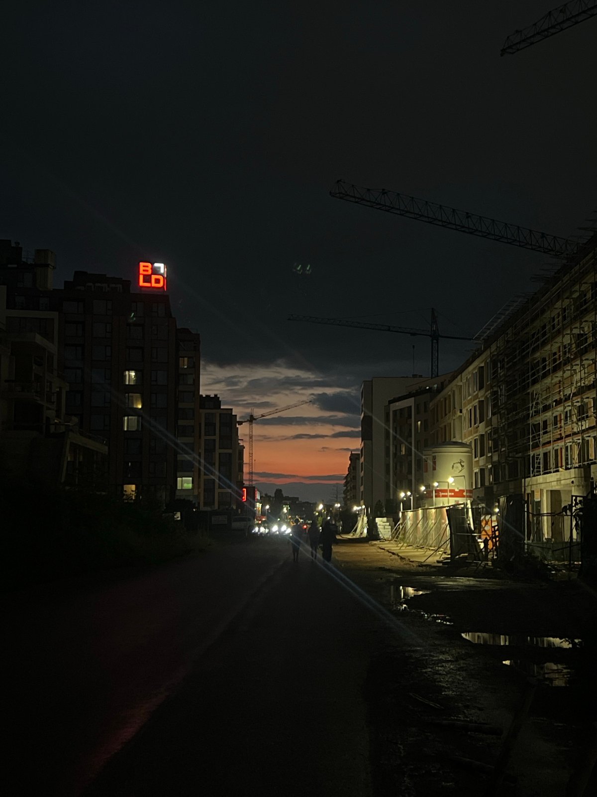 Sofia evening captures construction cranes and bilingual fortune message