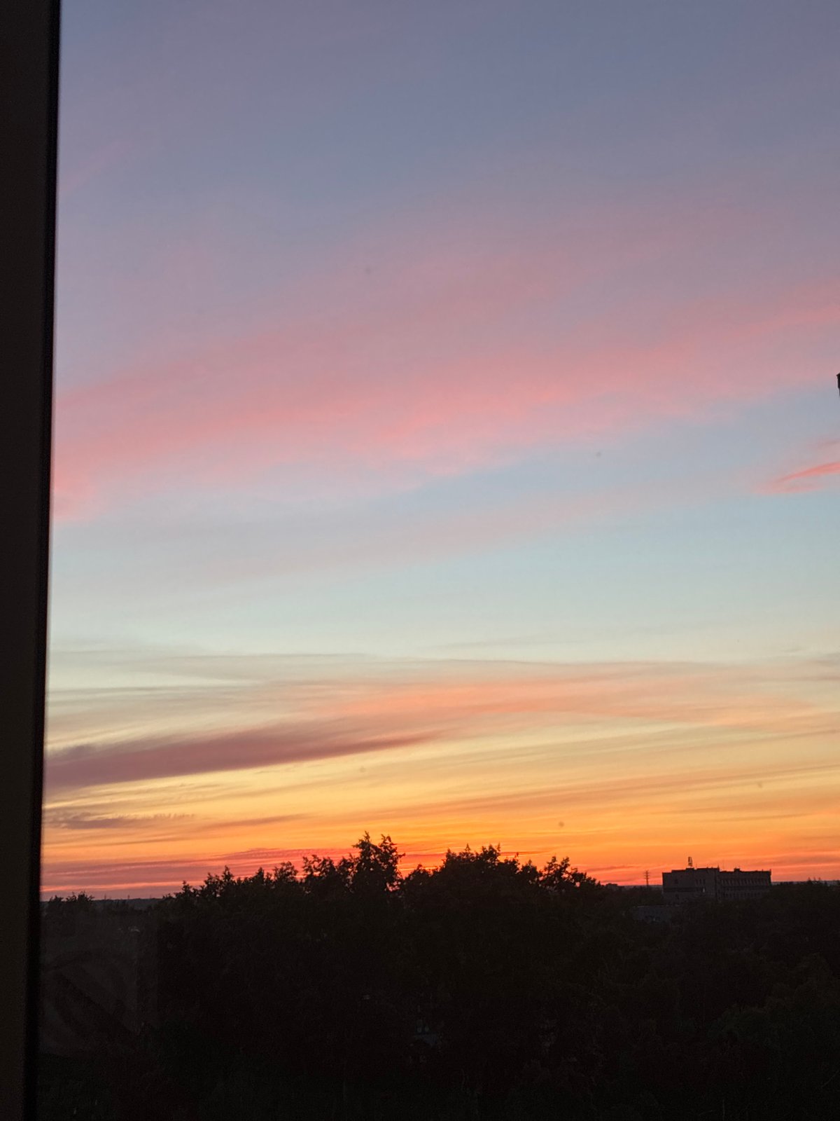 Vibrant sunset illuminates urban skyline in evening display