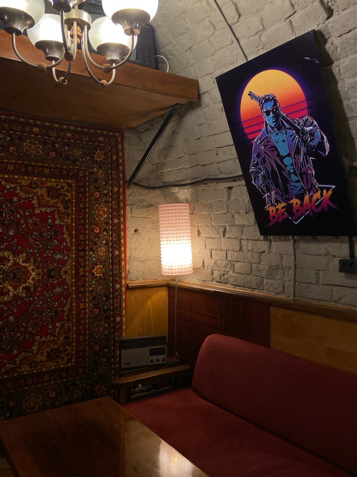 Indoor space displays vintage-modern mix with sunset character poster